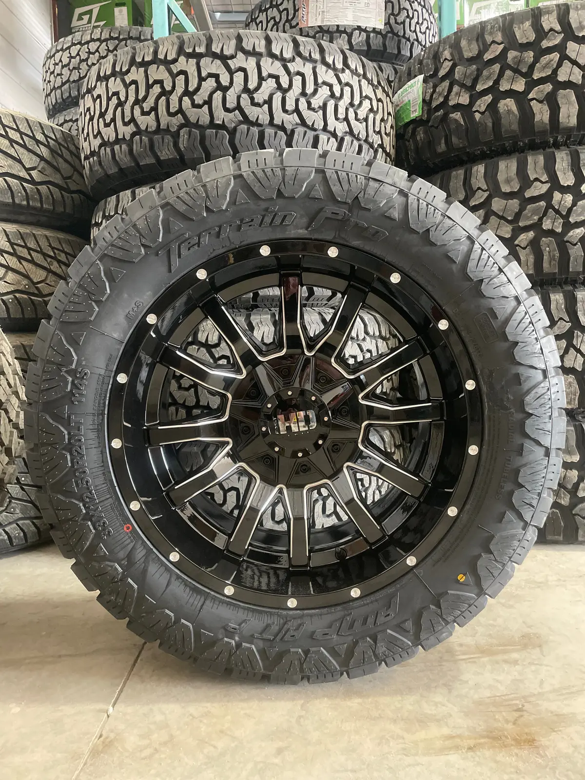 (Set Of Four) Fast Traxx 20X10 6X135/6X139.7 -18 Gloss Blk Milled | 33X12.50R20 Amp Terrain Pro 1
