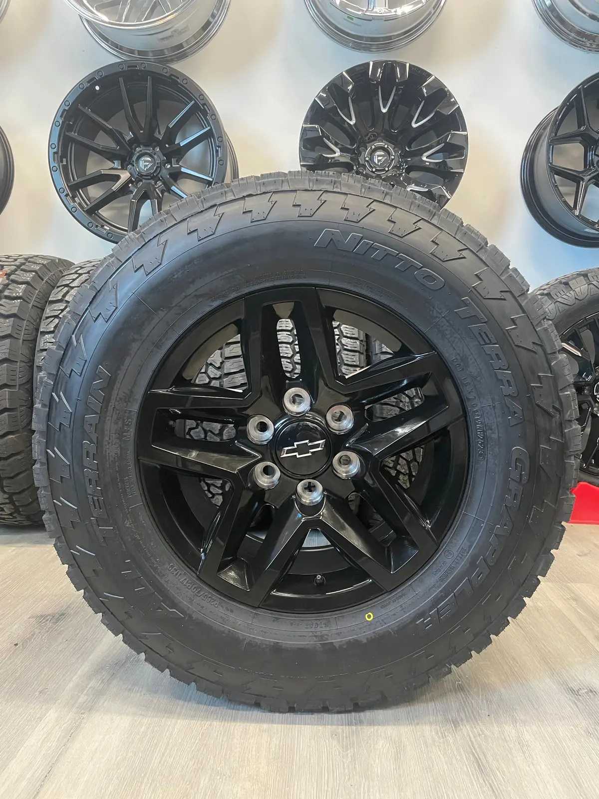 (Set Of Four) Chevy/Gmc Trailboss Oem R245 17X8 6X139.7 +24 Gloss Blk | 265/70R17 Nitto Terra Grappler  ( Sierra, Silverado, Yukon, Tahoe ) 1