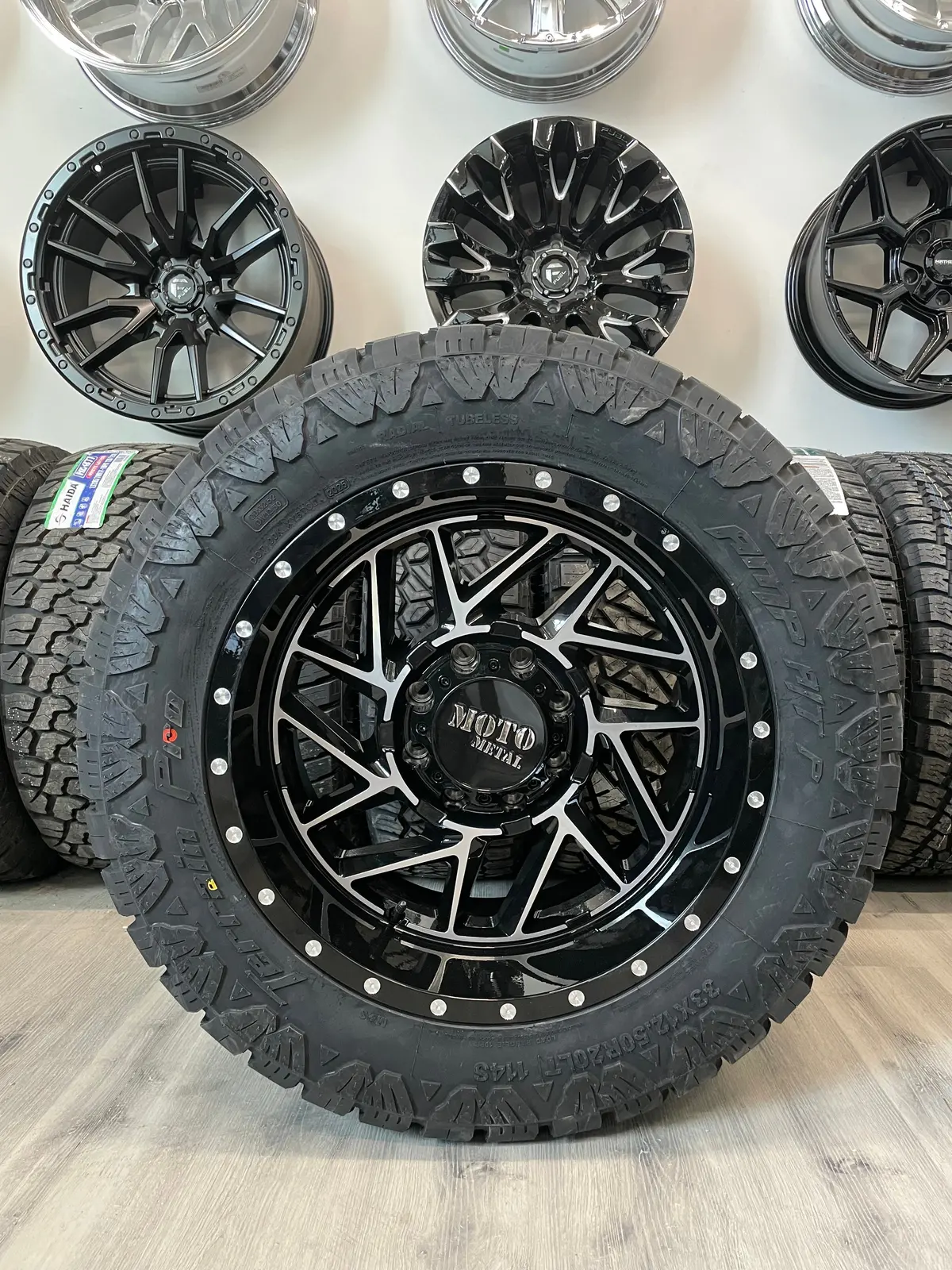 (Set Of Four) Moto Metal Breakout 20X10 8X165.1 -18 Gloss Blk Machined | Lt33x12.50R20 Amp Terrain Pro 1